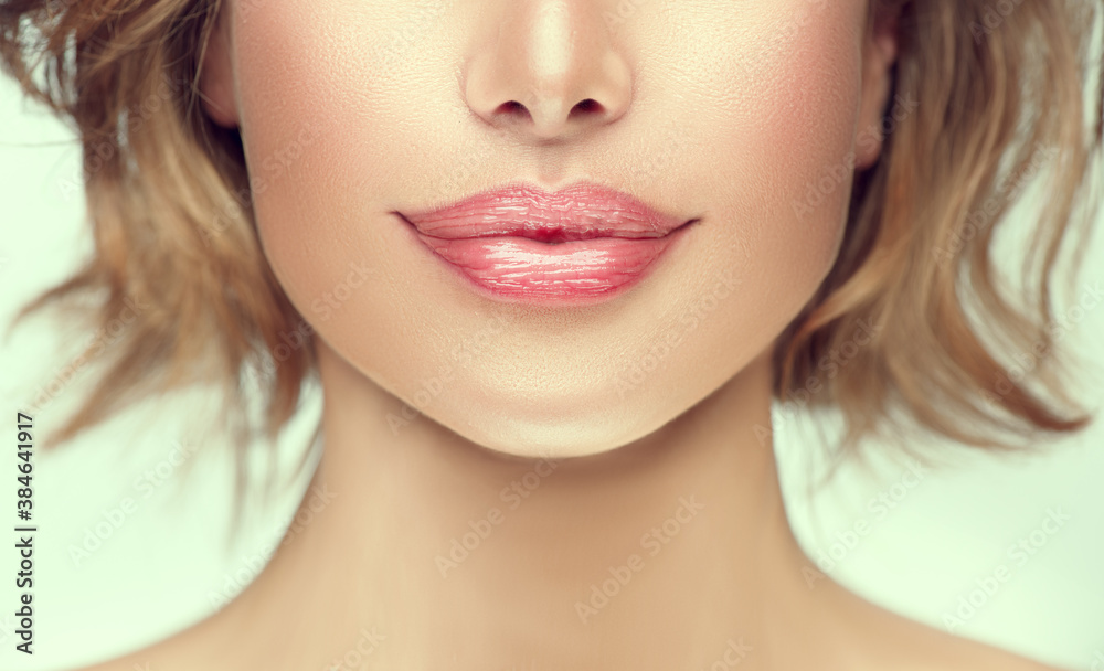 Beautiful young woman's lips closeup. Plastic surgery, fillers, injection. Part of the model girl face, youth concept. Perfect healthy skin. Natural make-up. Chin. Youth and beauty. Health care Beautiful young woman's lips closeup. Plastic surgery, fillers, injection. Part of the model girl face, youth concept. Perfect healthy skin. Natural make-up. Chin. Youth and beauty. Health care
