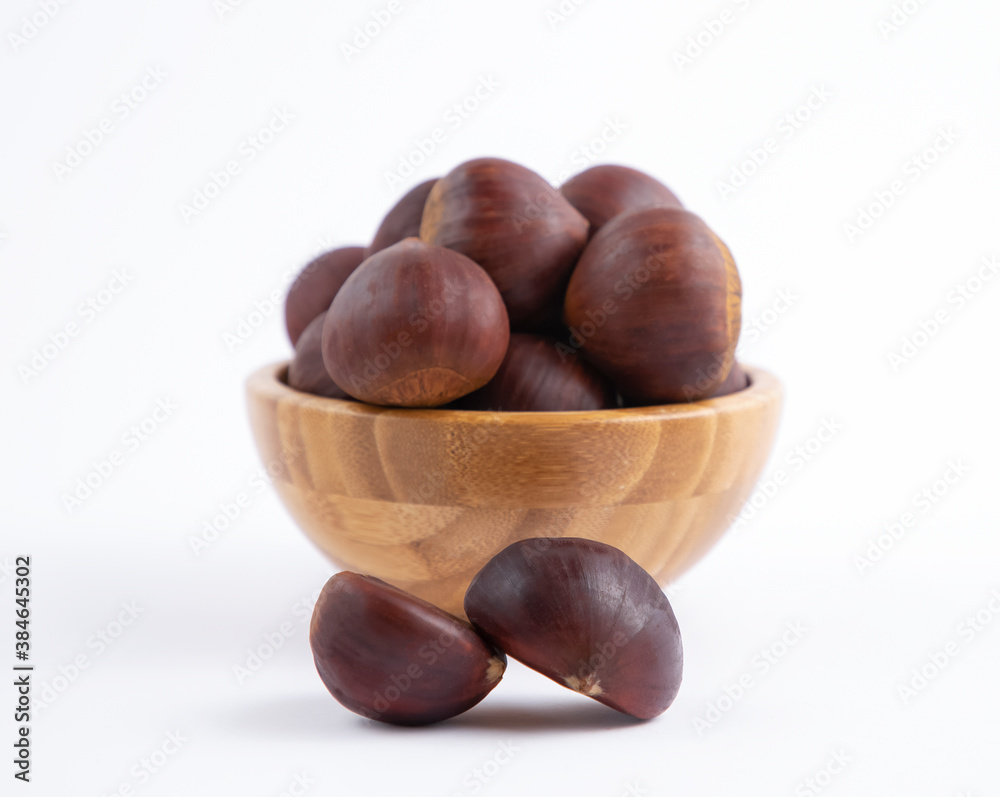 Fresh Chestnuts fruit isolated in wooden bowl on white background Fresh Chestnuts fruit isolated in wooden bowl on white background