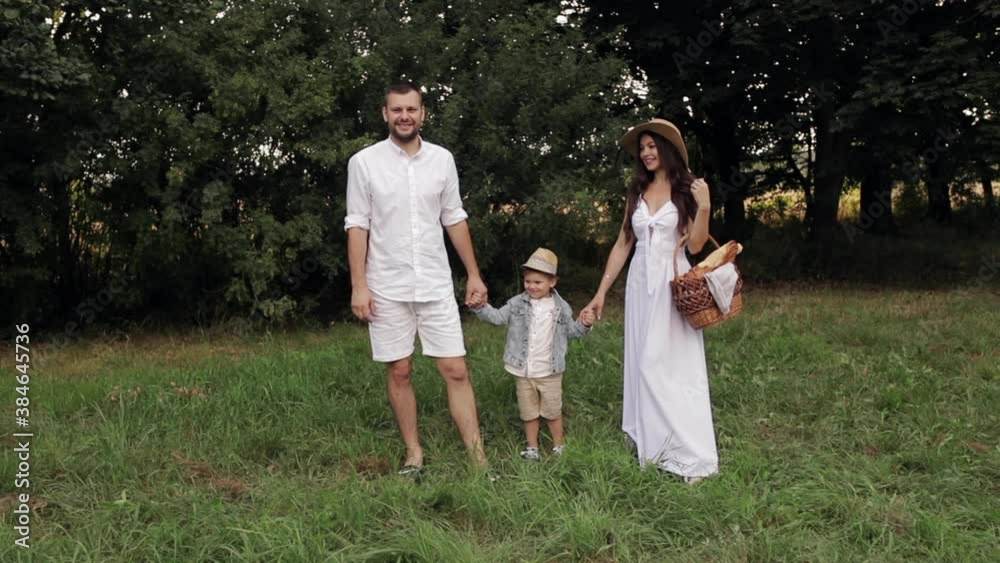 Happy caucasisn family with one beautiful child before a picnic in the park Happy caucasisn family with one beautiful child before a picnic in the park