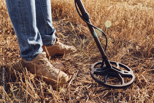 Billede på lærred Man with metal detector equipment searching for metal goods in the field