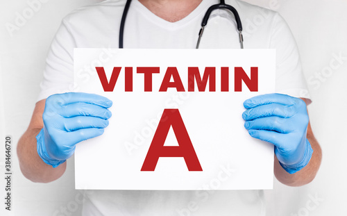 The male doctor holding a card with Vitamin A text, Medical concept. treatment and prevention with vitamins