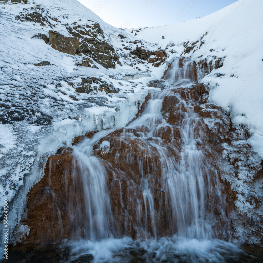 Small waterfall in winter, Northwest Iceland.