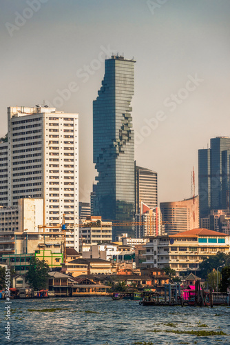 City Skyline as Seen from the Tourist Boat on Chao Phraya River at Sunset in Bangkok, Thailand