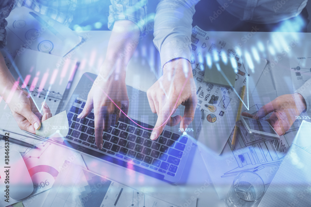 Double exposure of man and woman working together and forex graph hologram drawing. Financial analysis concept. Computer background. Top View. Double exposure of man and woman working together and forex graph hologram drawing. Financial analysis concept. Computer background. Top View.