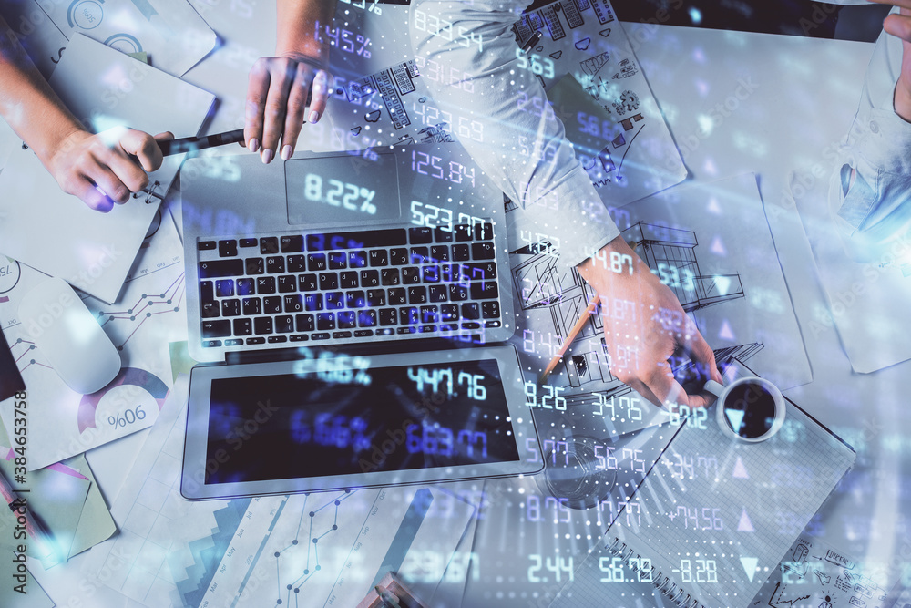 Double exposure of man and woman working together and financial graph hologram. Business concept. Computer background. Double exposure of man and woman working together and financial graph hologram. Business concept. Computer background.