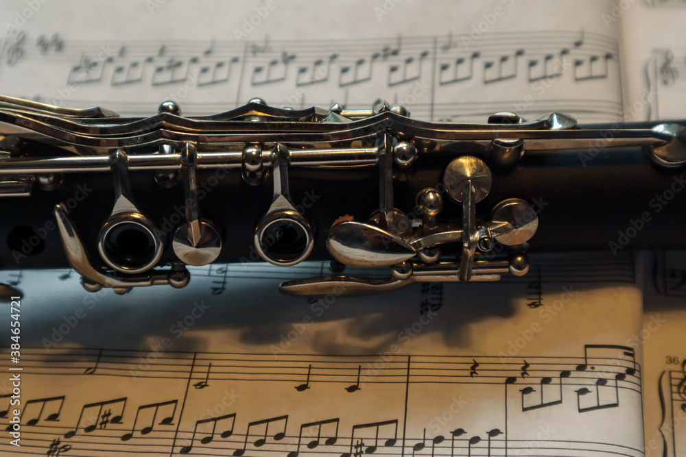 Fototapeta premium part of a clarinet against sheet music