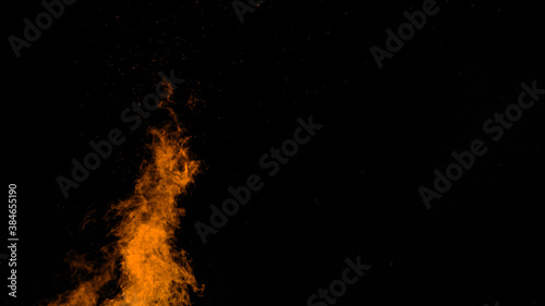 COPY SPACE: Orange flames reach up into the pitch black of tranquil summer night