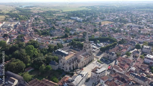 Scenic view from drone of small French town of Lucon overlooking magnificent Gothic cathedral in summer  photo