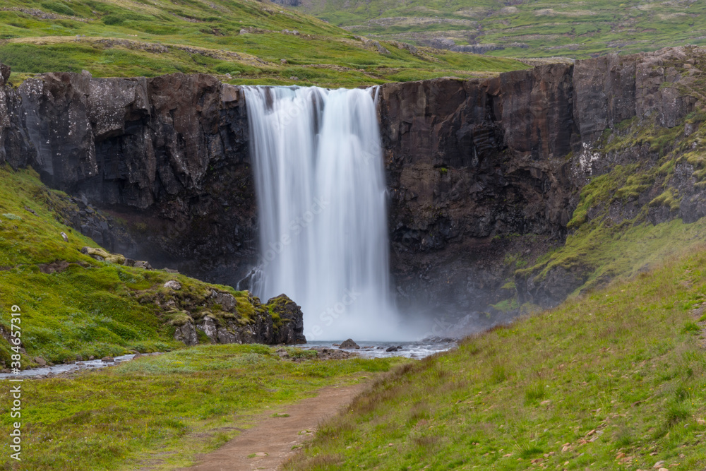 Waterfall gufufoss in river Fjardara in Seydisfjordur in east Iceland Waterfall gufufoss in river Fjardara in Seydisfjordur in east Iceland