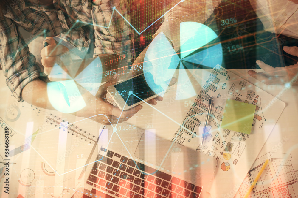 Double exposure of forex graph drawing and man and woman working together holding and using a mobile device. Trade concept.