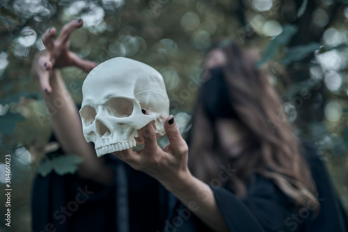 Young witch, preparation for the ritual, with a mask on