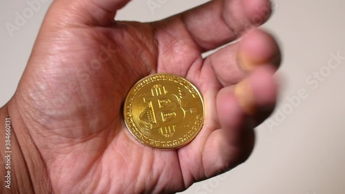 Black man hands closing around Bitcoin