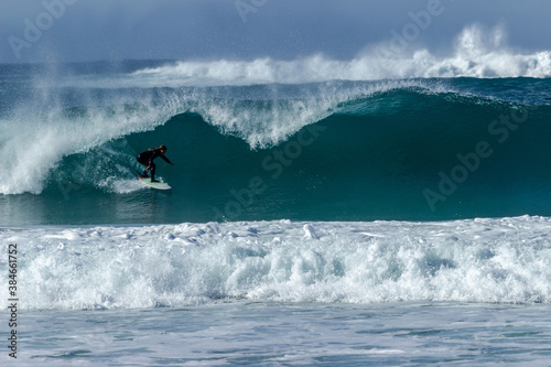 Canvas Print Woman surfing near the town of Carmel on the pacific coast of California