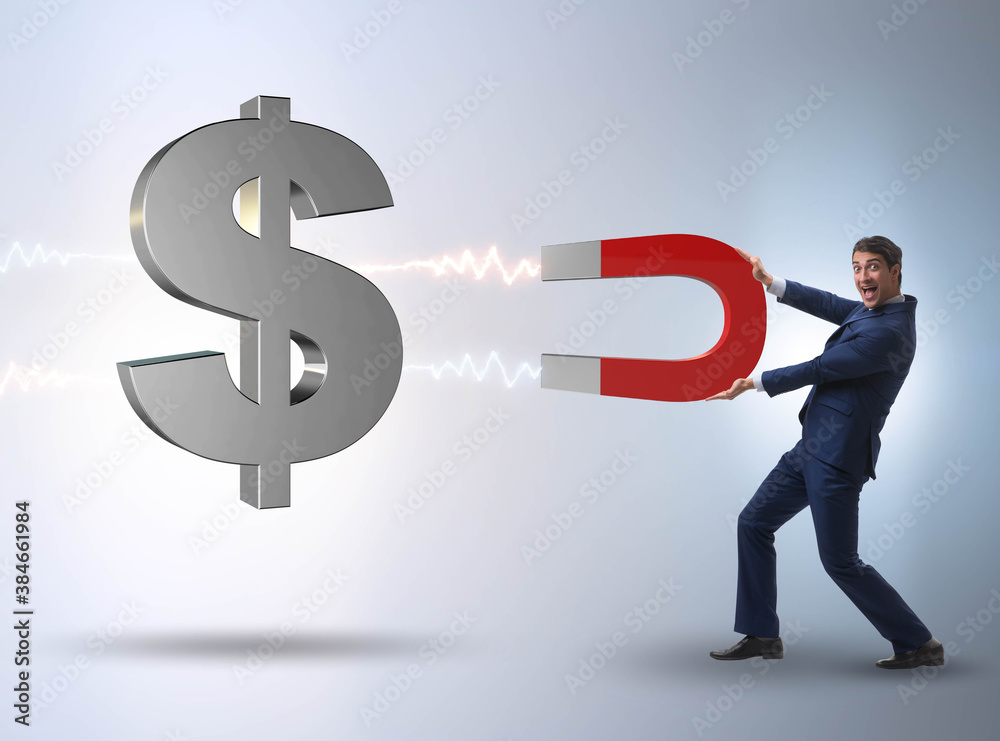 Businessman catching dollars on horseshoe magnet Businessman catching dollars on horseshoe magnet