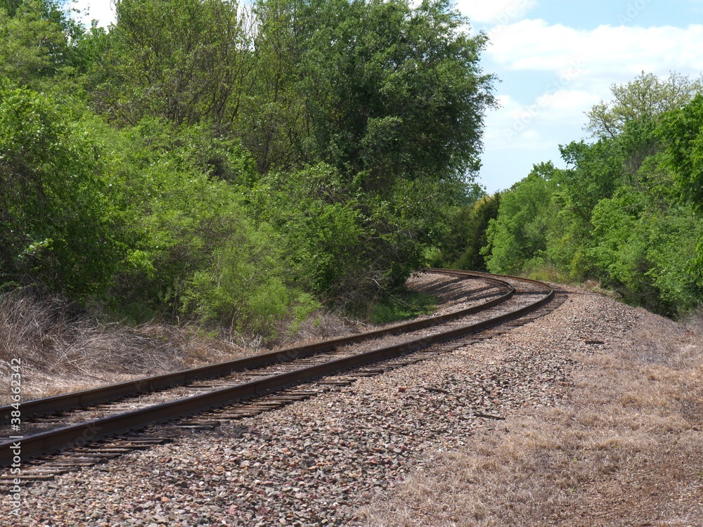 Fototapeta premium Curving railroad track in the outskirts of a city