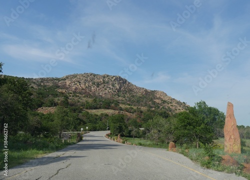 Mt. Scott at Comanche County, Oklahoma, with a sign on the road for the schedule of the access road availability. photo