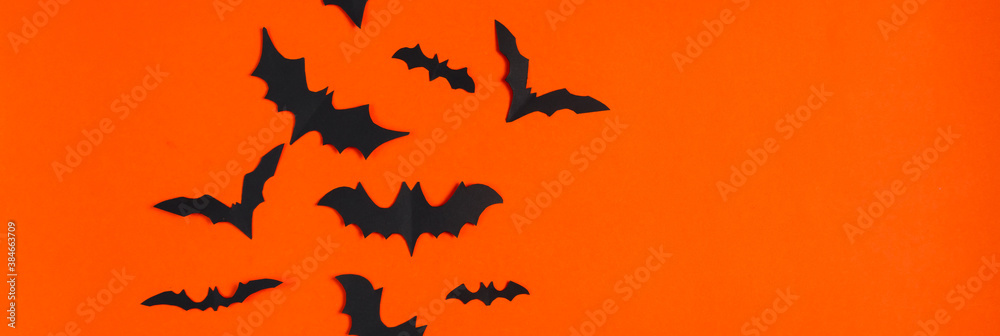Fototapeta premium Halloween concept. Festive decorations. Bats on orange background.