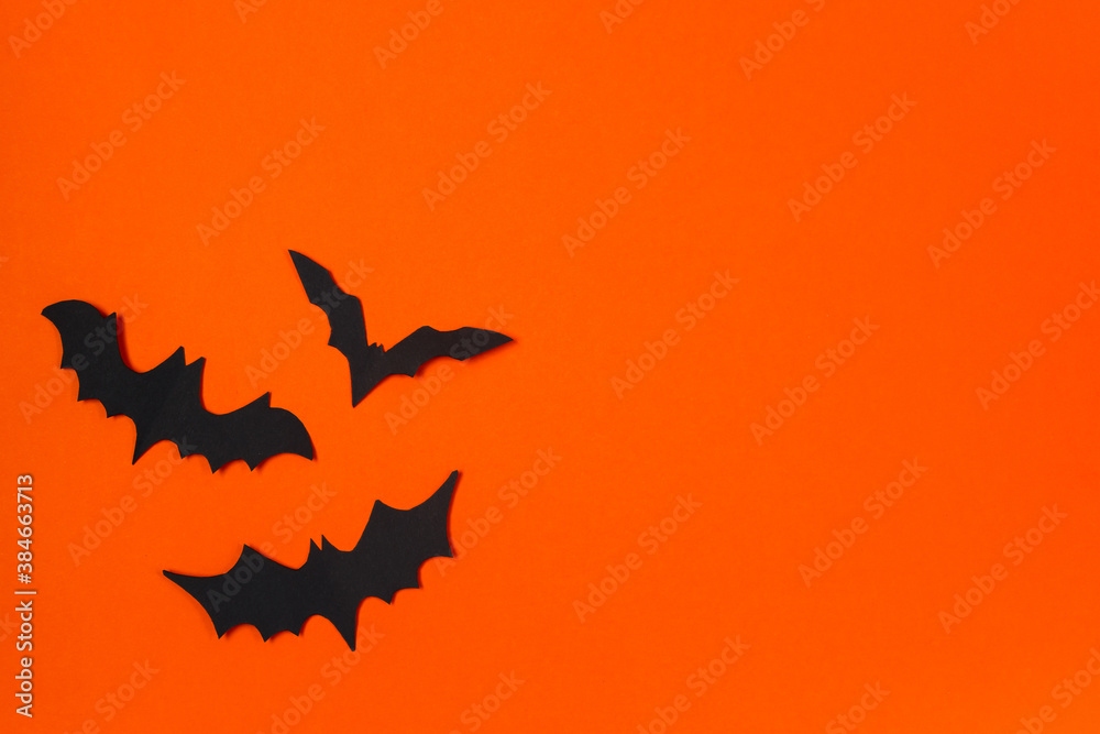 Fototapeta premium Halloween concept. Festive decorations. Bats on orange background.