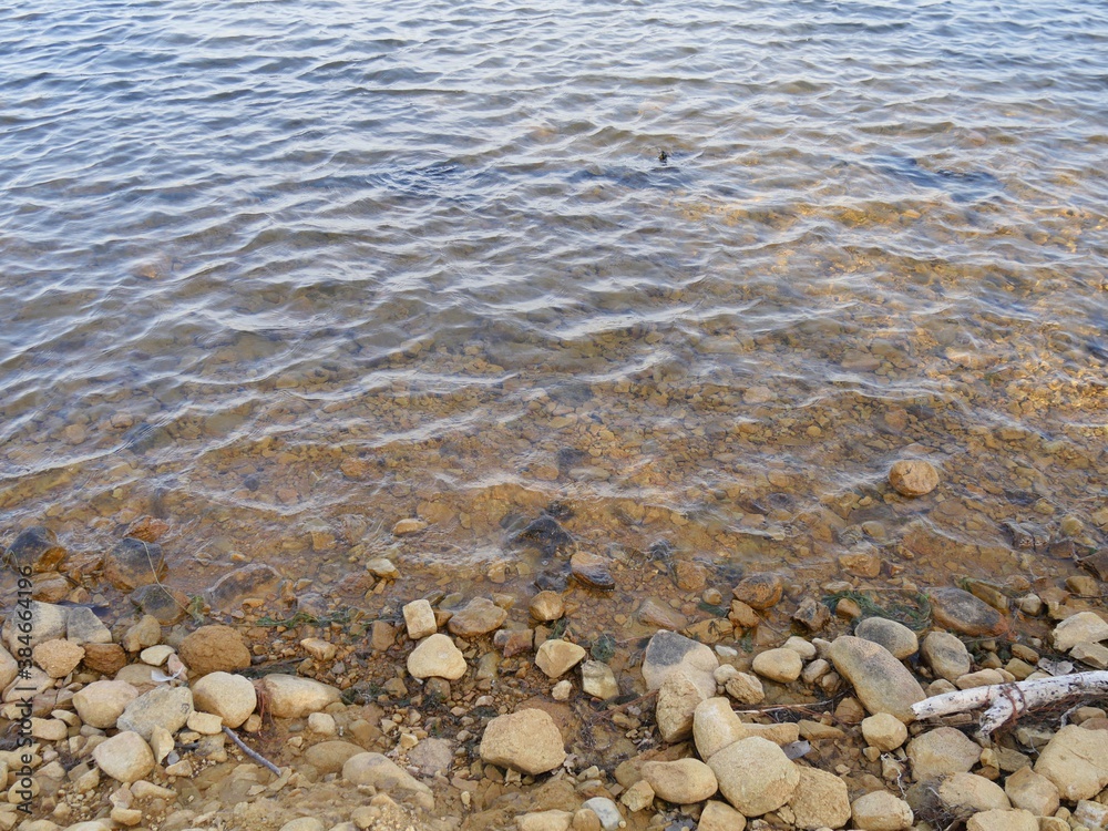 Close up of water rippling to the shores of a lake