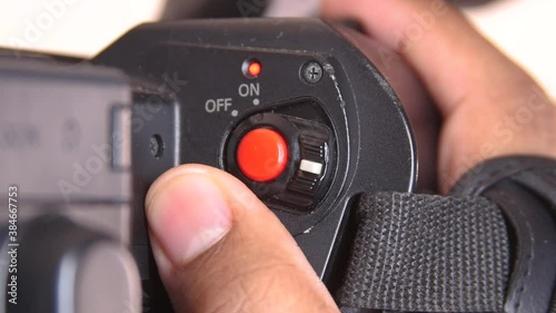 Close up of black man operating record button on Camcorder