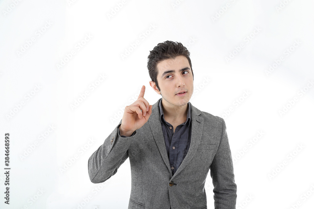 Middle eastern Caucasian young office business man wearing suit point finger up thinking planning on white studio background Middle eastern Caucasian young office business man wearing suit point finger up thinking planning on white studio background