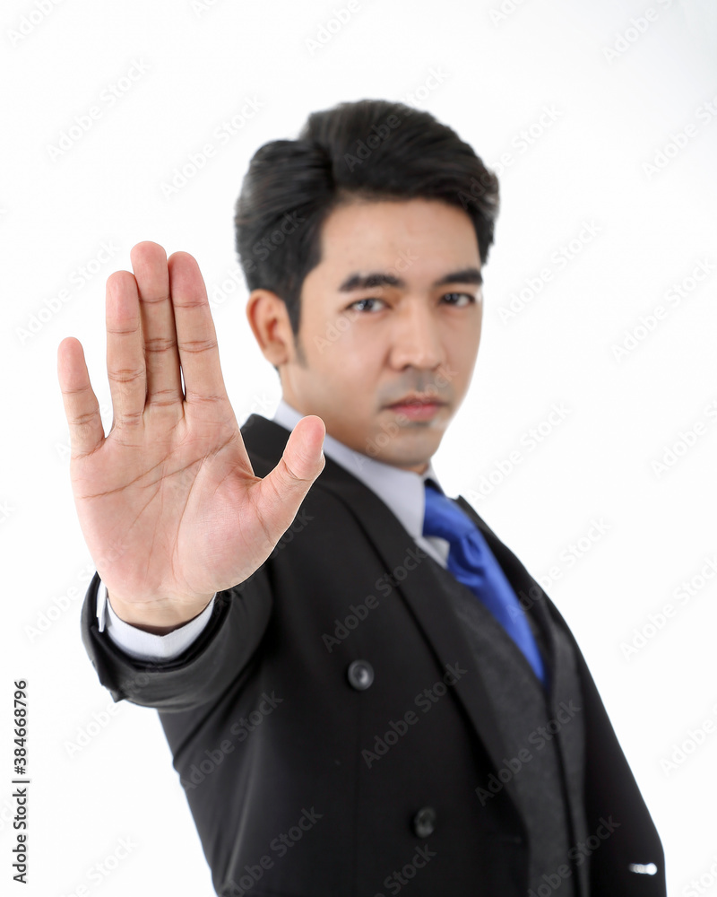 Southeast Asian young office business man wearing suit stop hand sign look at camera on white studio background Southeast Asian young office business man wearing suit stop hand sign look at camera on white studio background