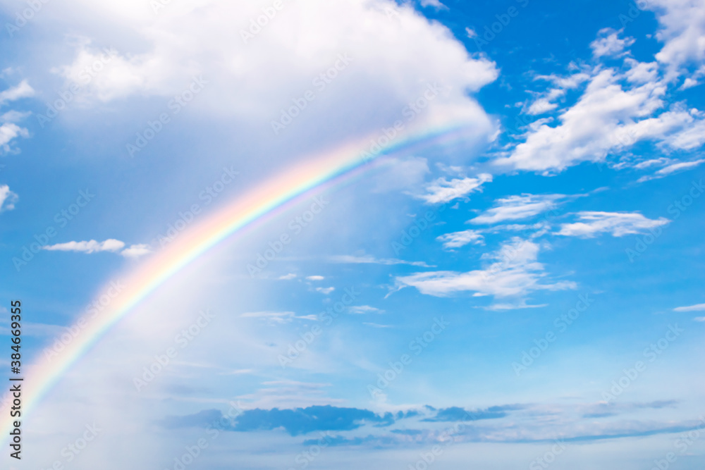 Beautiful colorful rainbow after rain against the blue sky. Background image Beautiful colorful rainbow after rain against the blue sky. Background image