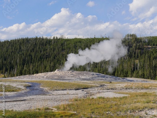 Scenic view of billows of steam and scalding water spurting out of Old Faithful Geyser during one its regular eruptions at Yellowstone National Park.