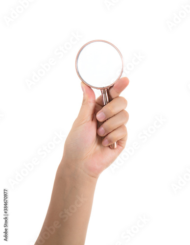 Hand holding a magnifying glass on white background