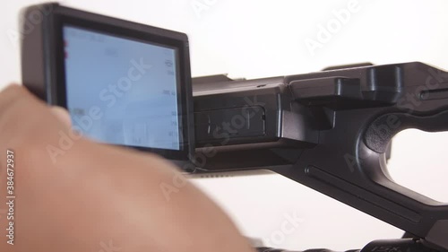 Black man using larger viewfinder on Camcorder