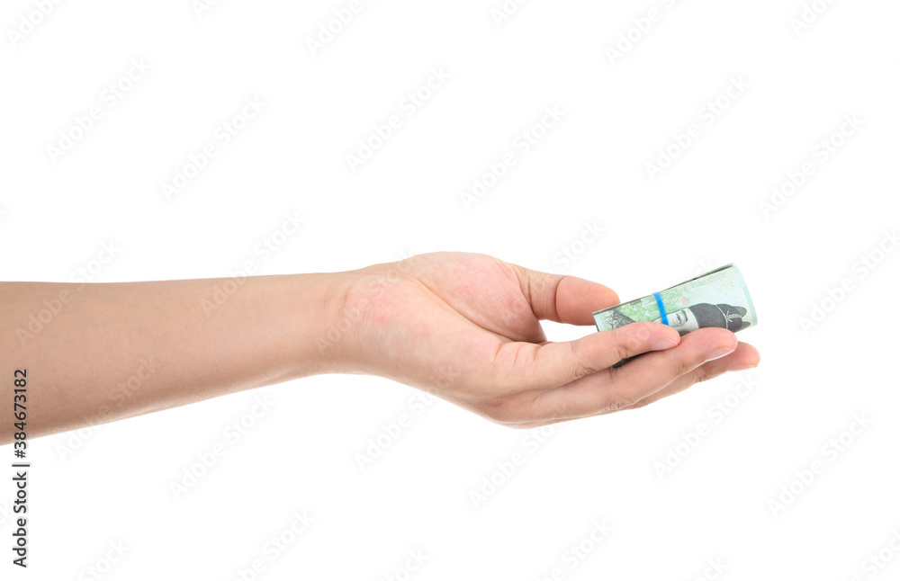In front of a white background, one hand is holding Korean won banknotes and doing the gesture of giving In front of a white background, one hand is holding Korean won banknotes and doing the gesture of giving