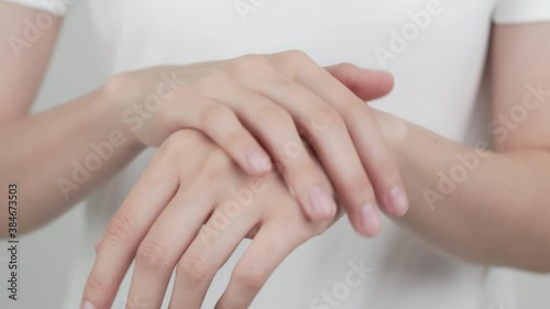 Close up of woman hand holding and applying moisturiser, Body lotion, isolated on white background.