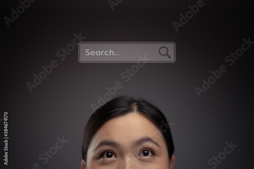 Close up shot of happy Asian woman with search icon hologram effect.