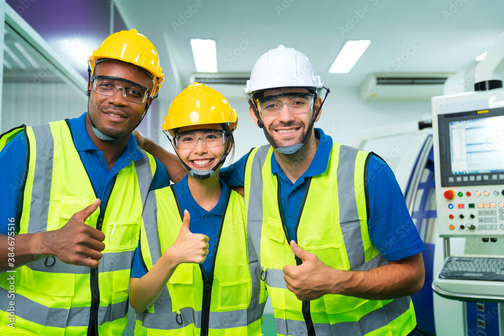 Close up portrait team of young multiethnic group male and female technician staff wearing a protective helmet. Happy teamwork laugh smile posing at camera smiling. Close up portrait team of young multiethnic group male and female technician staff wearing a protective helmet. Happy teamwork laugh smile posing at camera smiling.