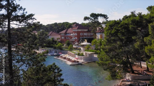 Slow aerial of a beautiful resort with umbrellas in the island of Losinj photo