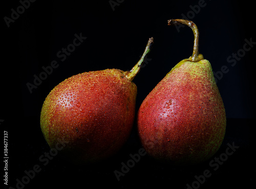 Very beautiful ripe pear on a black background.