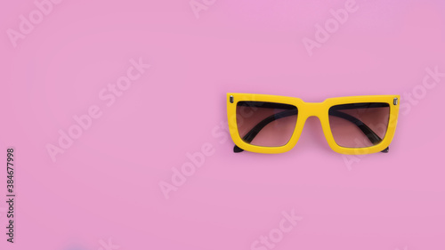 Modern fashionable sunglasses on pink background