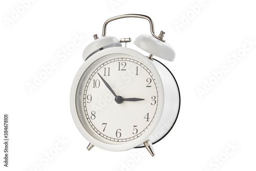 White vintage alarm clock on a white background isolated