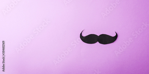 Black mustache paper, studio shot isolated on purple background, Prostate cancer awareness month, Fathers day, minimal November moustache concept