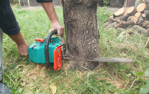 Man cutting wood with a chainsaw.