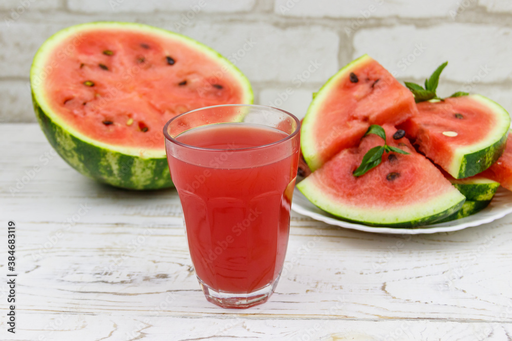 Glass of fresh watermelon juice on a white wooden table Glass of fresh watermelon juice on a white wooden table