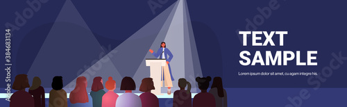 woman speaking to audience from tribune women's club girls supporting each other union of feminists concept conference hall interior horizontal full length copy space vector illustration