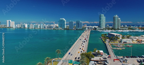Miami, Florida. Aerial view of MacArthur Causeway and surrounding skyline from drone on a sunny day. © jovannig