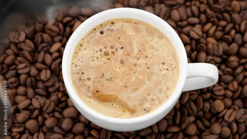 Pouring black coffee in cup. top view of coffee pour into cup from geyser coffee maker. coffee with froth Pouring black coffee in cup. top view of coffee pour into cup from geyser coffee maker. coffee with froth