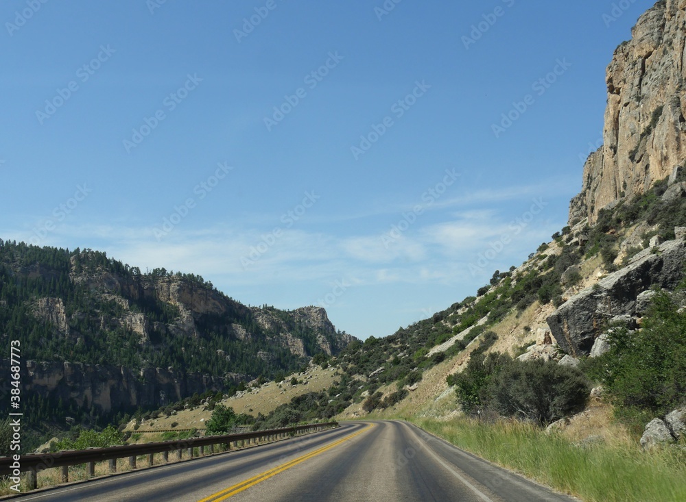 Scenic drive with geologic formations and cliffs through the Bighorn Mountains in Wyoming, USA.