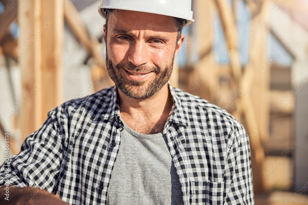 Responsible field engineer wearing protective head gear at construction site Responsible field engineer wearing protective head gear at construction site