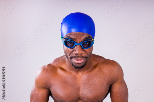 african american man trainer has wet muscular body, being in good mood after swimming and diving