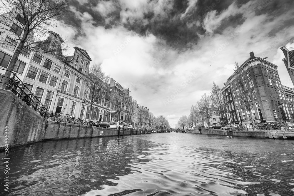 AMSTERDAM, THE NETHERLANDS - APRIL 25, 2015: Traditional houses and buildings on the canal