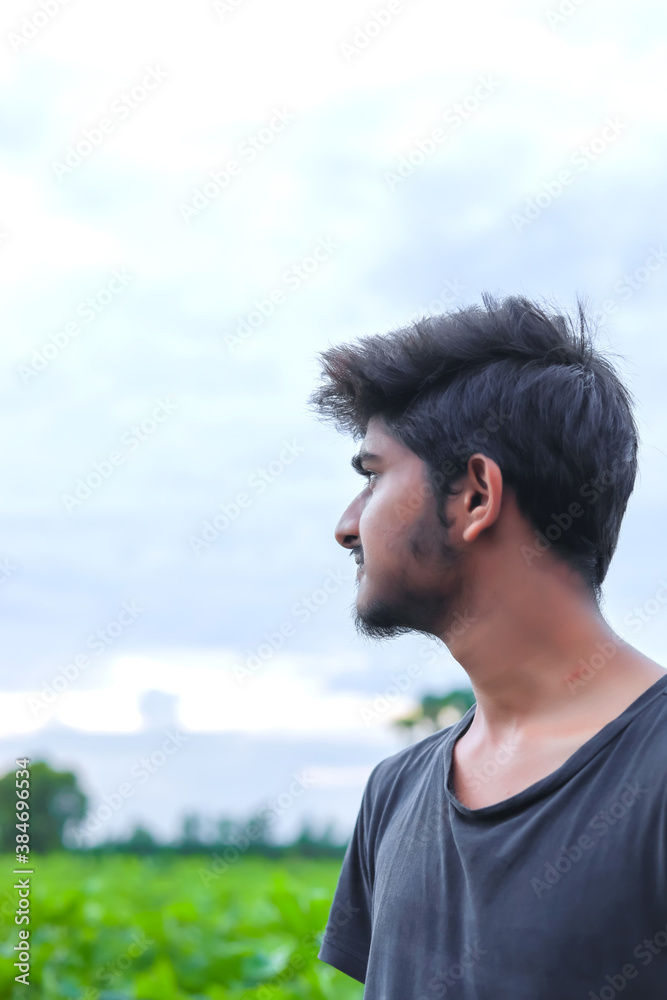 Young indian college student in cotton field Young indian college student in cotton field