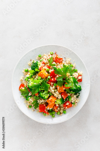 Quinoa and broccoli vegetable salad with baked butternut squash or pumpkin, green peas, bell pepper and parsley